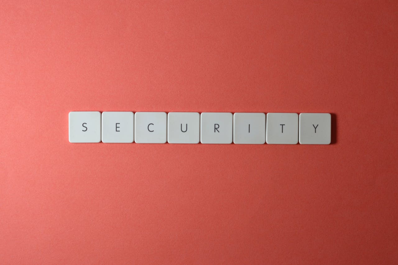 A conceptual image of the word security spelled with keyboard keys on a red surface, providing copy space.